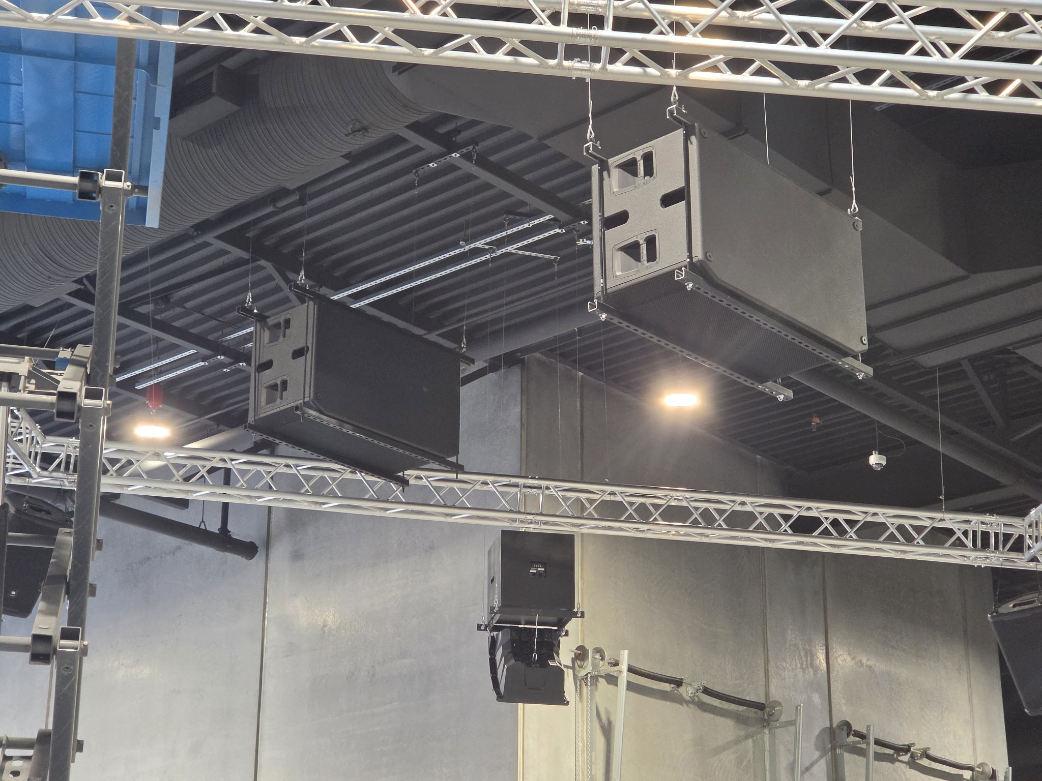 Flown subwoofers on truss at Iron Lore Gym