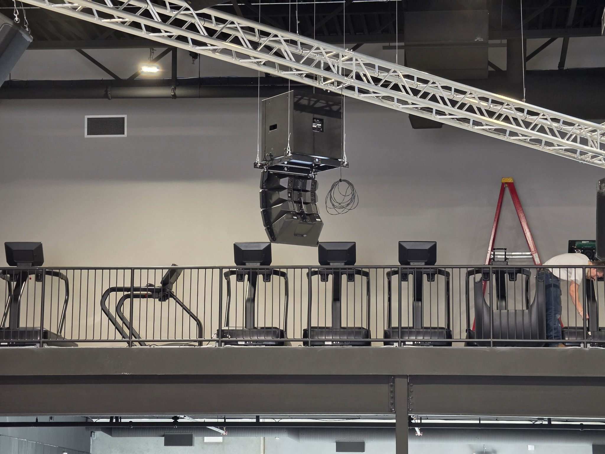 Flown speaker cluster over gym mezzanine